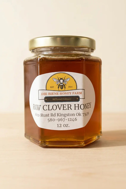 Die Biene Honey Farm raw clover honey in a 12 oz glass jar on a light wood surface